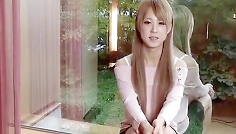 Asian transsexual stripper strips naked in the bedroom